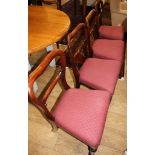 A set of five Victorian mahogany buckle back dining chairs with stuffover seats and a similar chair