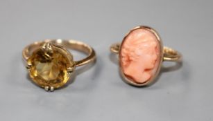 A yellow metal and coral oval cameo ring and a 9ct and citrine set ring. Cameo ring size F,