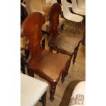 A pair of Victorian mahogany hall chairs