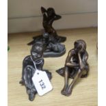 A small bronze kneeling nude, initialled 'TG', edition of 30, a similar seated nude and two