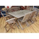 A teak garden table, bench and five chairs Table 150cm