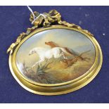 A 19th century oval porcelain plaque depicting horses fleeing from a lion, in gilt frame with ribbon