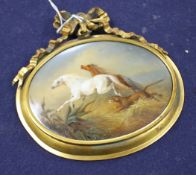 A 19th century oval porcelain plaque depicting horses fleeing from a lion, in gilt frame with ribbon