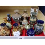 Thirteen Doulton miniature vases and a jug