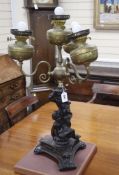 An ornate putti spelter three branch four light table lamp height 76cm