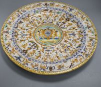 A 19th century Italian 17th century style maiolica charger, decorated with cherubs flanking a