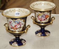 A pair of Victorian Derby style campana vases, painted with panels of flowers within gilt cobalt