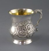 A George III Irish silver mug by Matthew West, of baluster form, with later? embossed foliate and