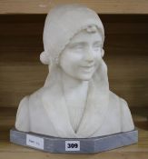 An early 20th century North European carved alabaster bust of a Flemish girl wearing a lace