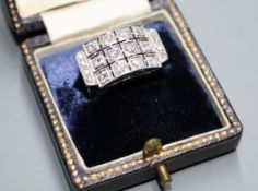 A white metal (stamped 750 and Pt 950) and pave diamond set cocktail ring, of curved design and