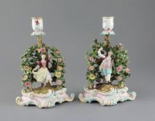 A pair of Meissen figural candlesticks, late 19th century, each modelled with a figure of either a