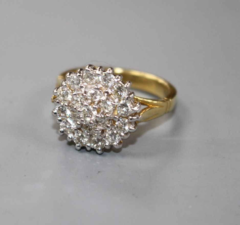 A modern 18ct gold and diamond cluster dress ring, size M, gross 7.8 grams.Condition- Two of the