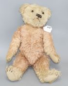 A c.1930's bear, possibly Farnell, 22in., faded pink mohair, original paw pads, good condition