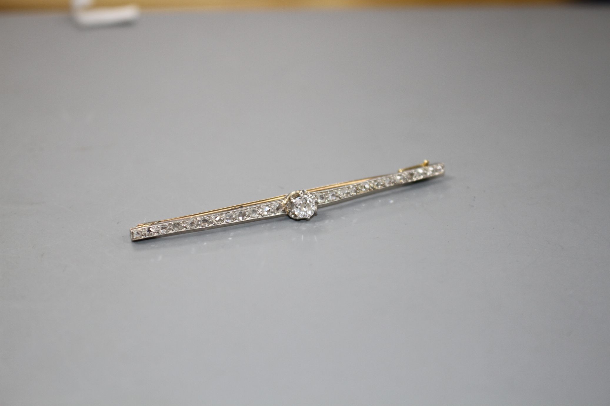 A 1920's yellow and white metal, diamond bar brooch, with central old cut diamond and millegrain set - Image 2 of 4