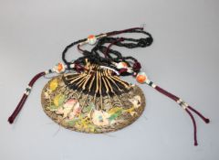 A Chinese silk purse and with four enamelled porcelain beads, late 19th century, the silk to the