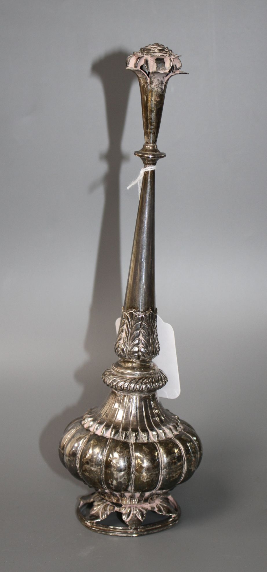 A 20th century Indian? white metal rosewater sprinkler, on pierced circular foliate base, height