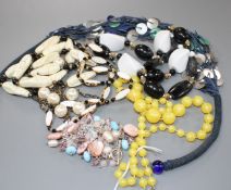 Six assorted costume necklaces including simulated amber and a costume bracelet, simulated amber