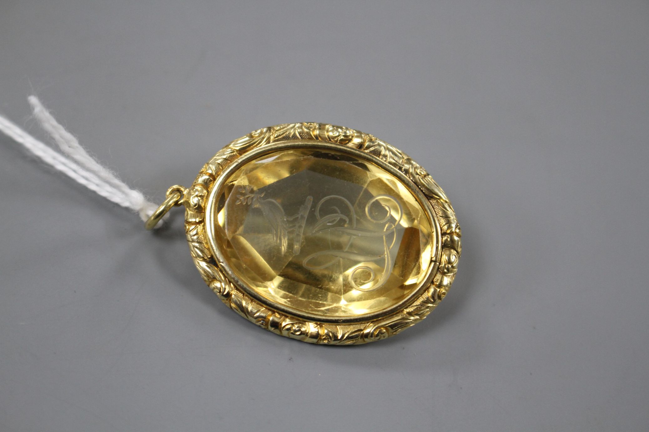 A late Victorian gilt metal mounted oval citrine pendant, engraved with a crested initial, 33mm - Image 3 of 3