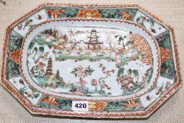 An 18th century Chinese famille verte octagonal meat plate, decorated with pagodas in a garden,