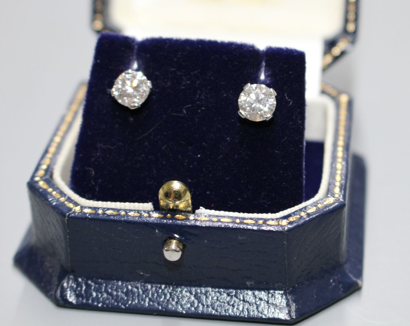 A pair of 18ct white gold and solitaire diamond ear studs, with an approximate total carat weight of