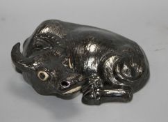 A Chinese black enamelled biscuit porcelain figure of a recumbent ox, probably early 20th century,