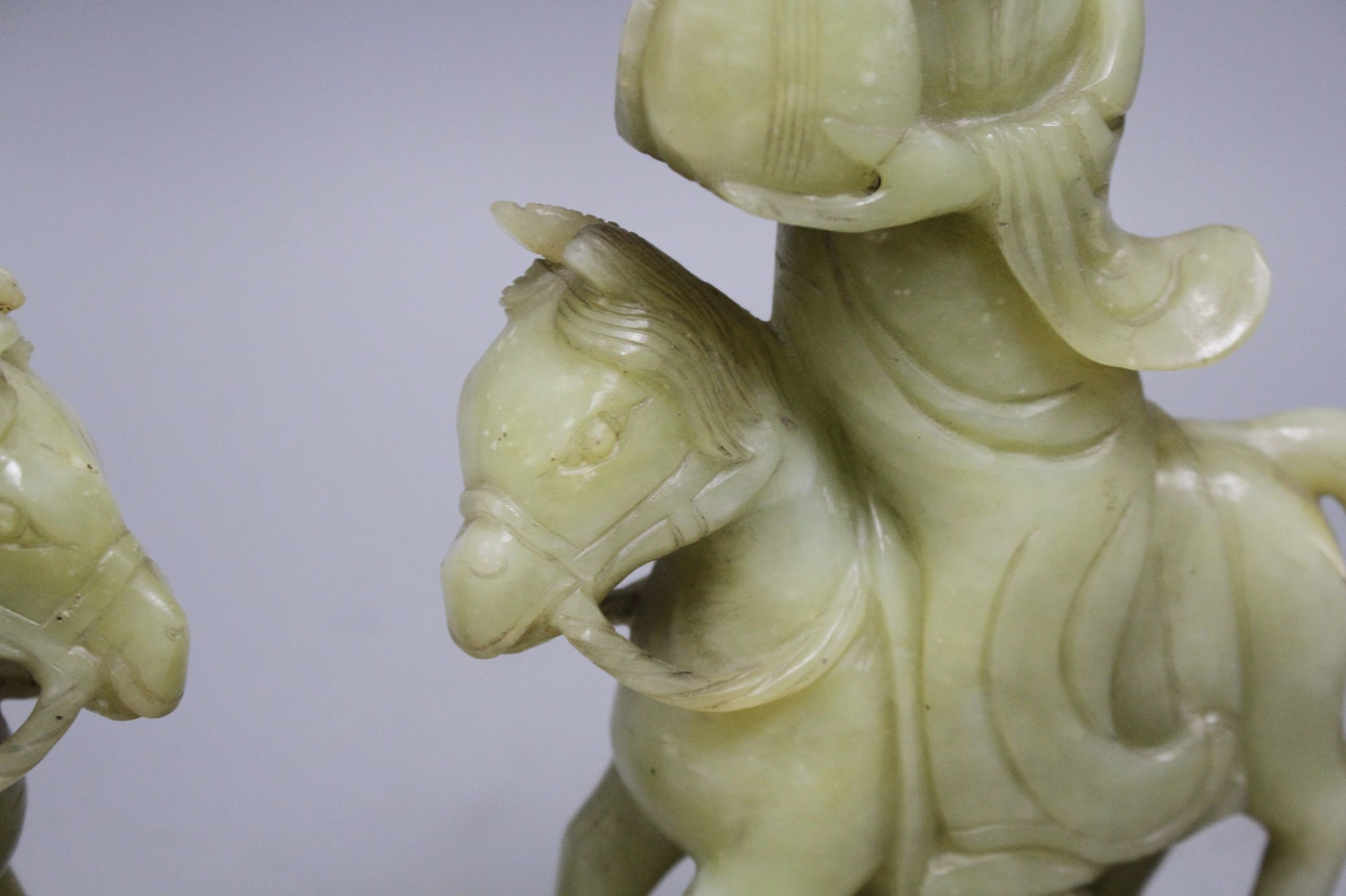 A pair of Chinese bowenite jade groups of a lady riding a horse, wood stands natural inclusions - Image 9 of 9