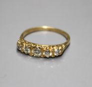 A modern 18ct gold and graduated five stone diamond half hoop ring, with carved setting, size