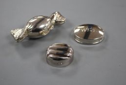 Three assorted modern silver pill boxes, including one modelled as a sweet and one engraved '