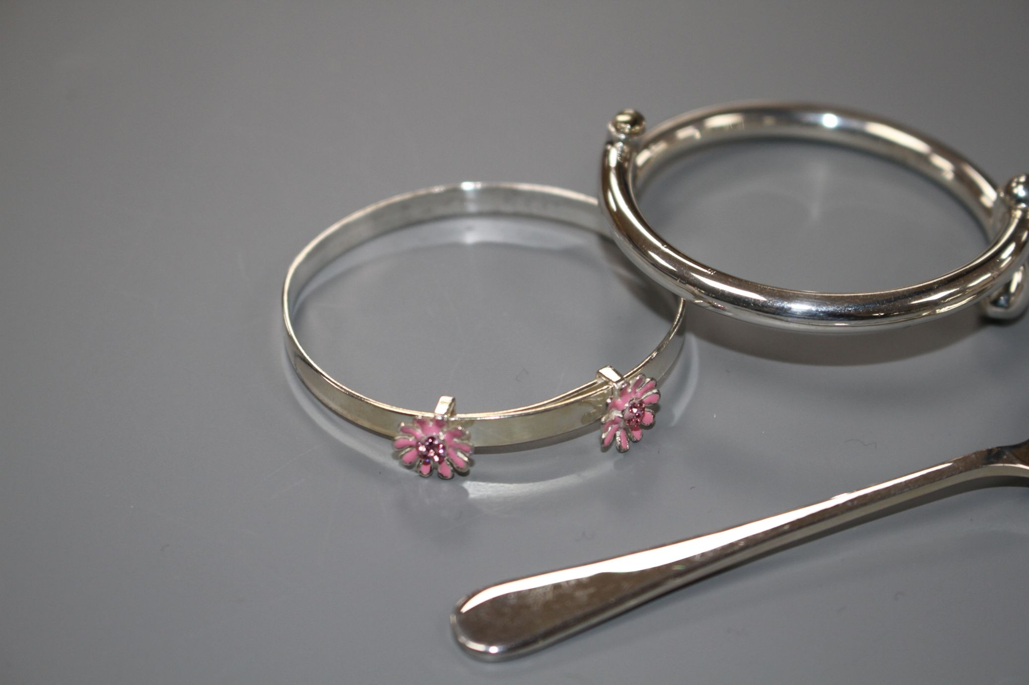 A modern silver coffee spoon and two 925 child's bangles, gross weight 31 grams. - Image 2 of 3