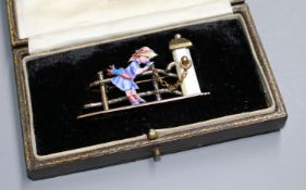 An early 20th century mixed metal, enamel and mother of pearl set 'Kate Greenaway' brooch, in fitted