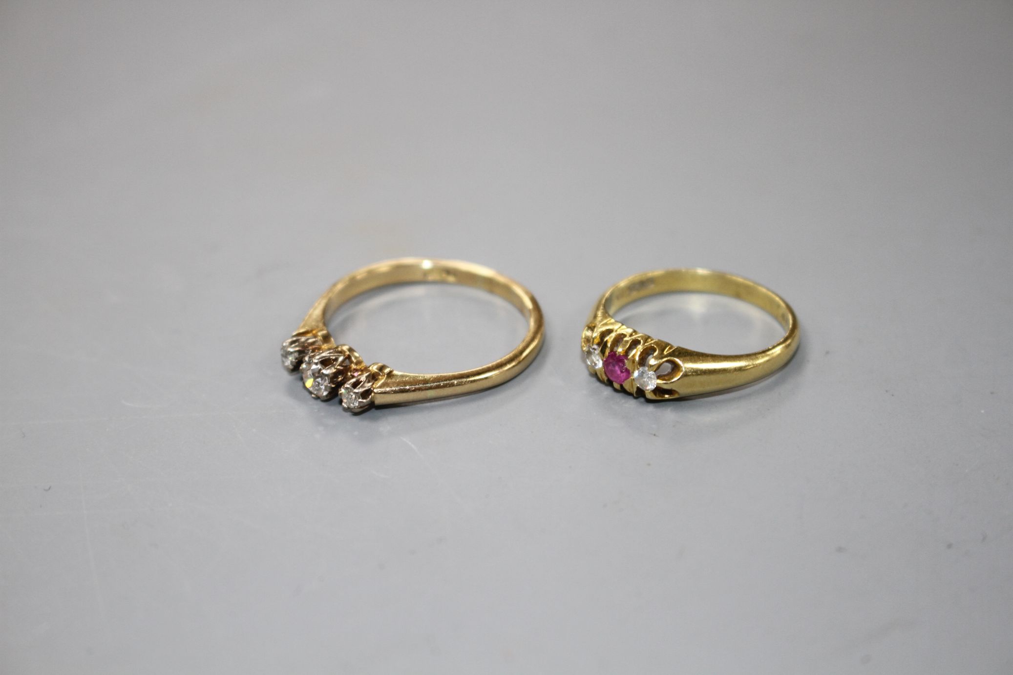 A modern 18ct gold, ruby and diamond set three stone ring and an 18ct and three stone diamond - Image 2 of 4