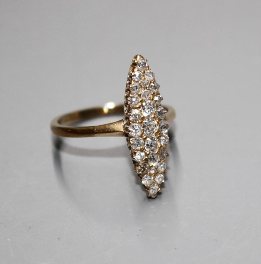 A yellow metal (tests as 18ct) and old round cut diamond set marquise cluster ring, with a total