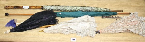 A group of assorted Victorian and later parasols including one with jewelled silver and ivory