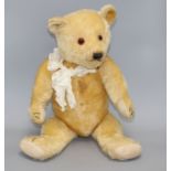 A Chiltern type bear, blond mohair, glass eyes, original pads, some slight staining on centre seam