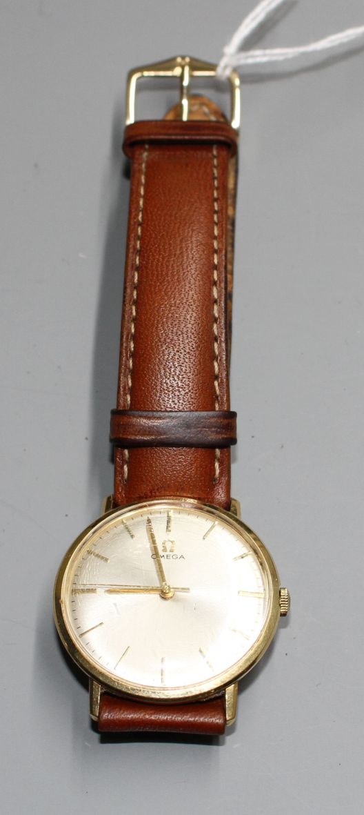 A gentleman's Omega manual wind wrist watch, on associated strap, with yellow metal? case.Condition: