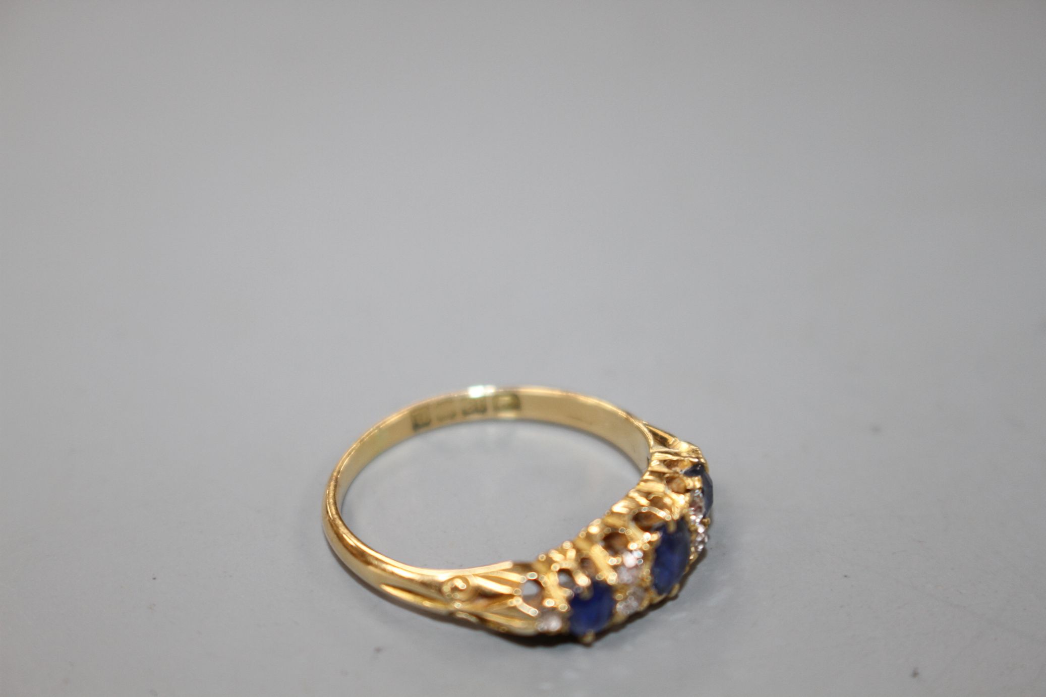 A George V 18ct gold, three stone sapphire and six stone diamond set half hoop ring, size M, gross - Image 4 of 5