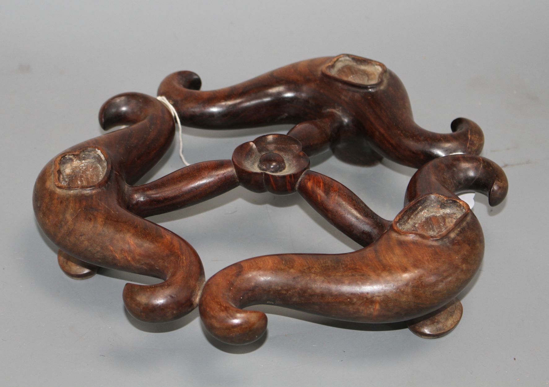 A large Chinese hardwood tripod censer stand, minor scuffs and fading to one side W. 28cm