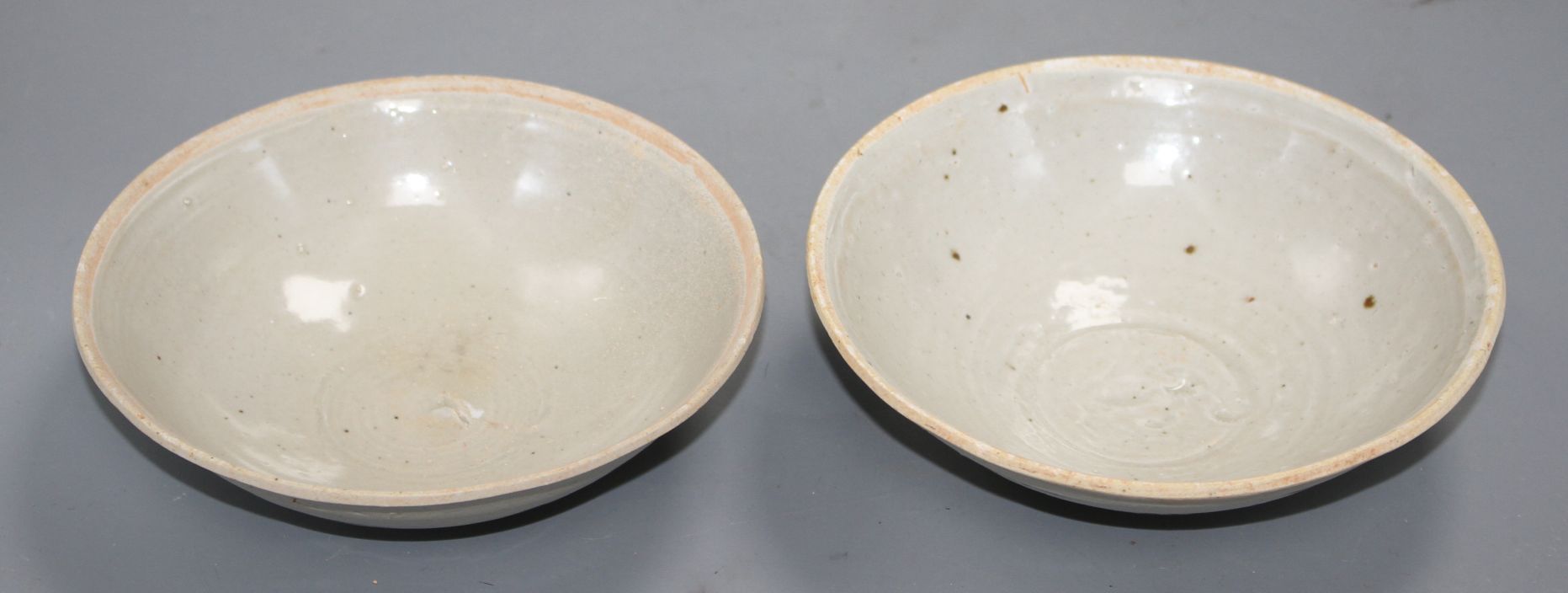 Two Chinese Ding type bowls, Yuan-Ming dynasty, with unglazed rims, both with minor scratching to