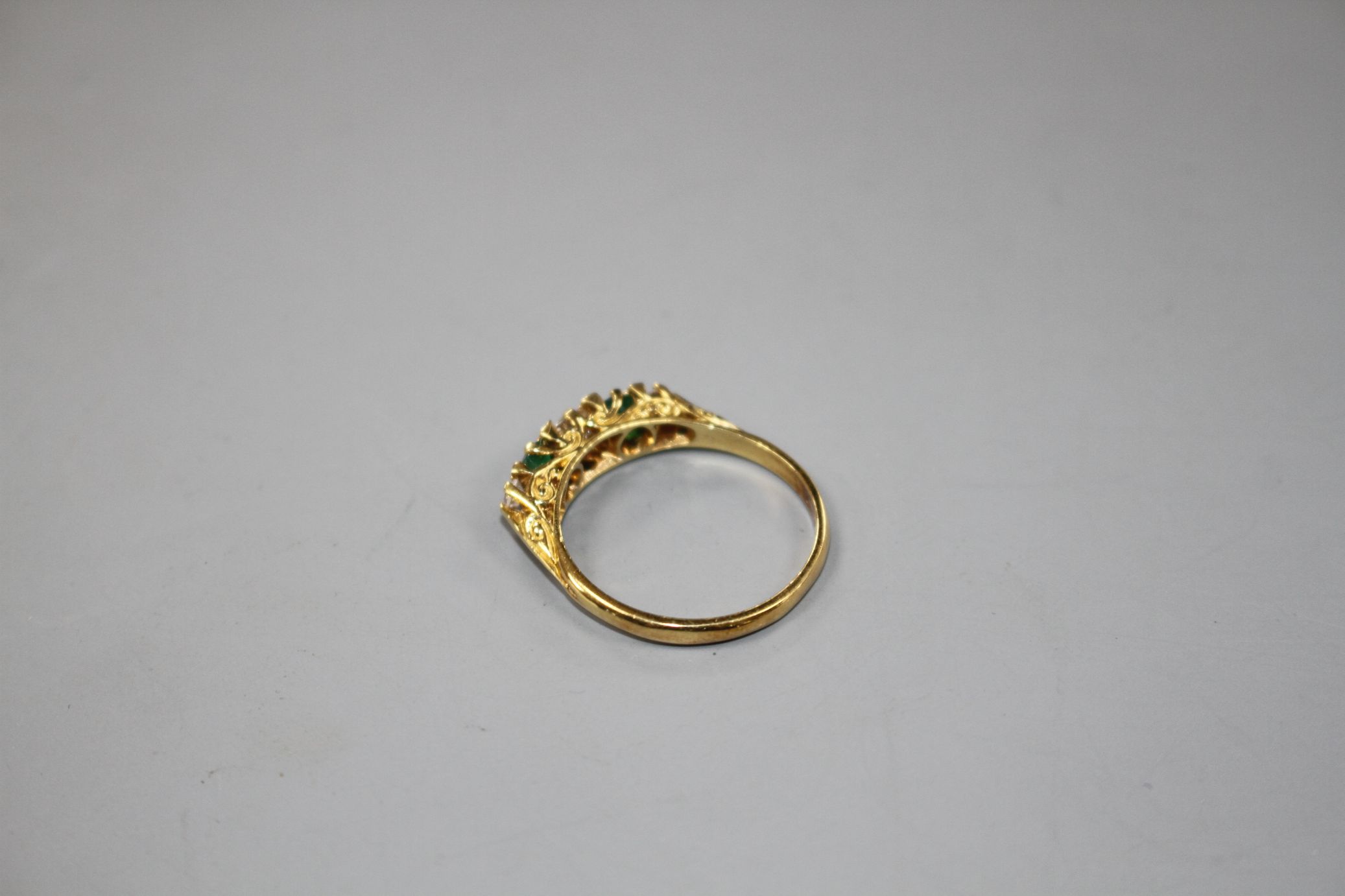 A modern Victorian style 18ct gold, two stone emerald and three stone diamond set half hoop ring, - Image 3 of 5