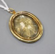 A late Victorian gilt metal mounted oval citrine pendant, engraved with a crested initial, 33mm