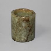 A Chinese celadon and brown jade cylinder, probably archaic, natural inclusions in the stone,