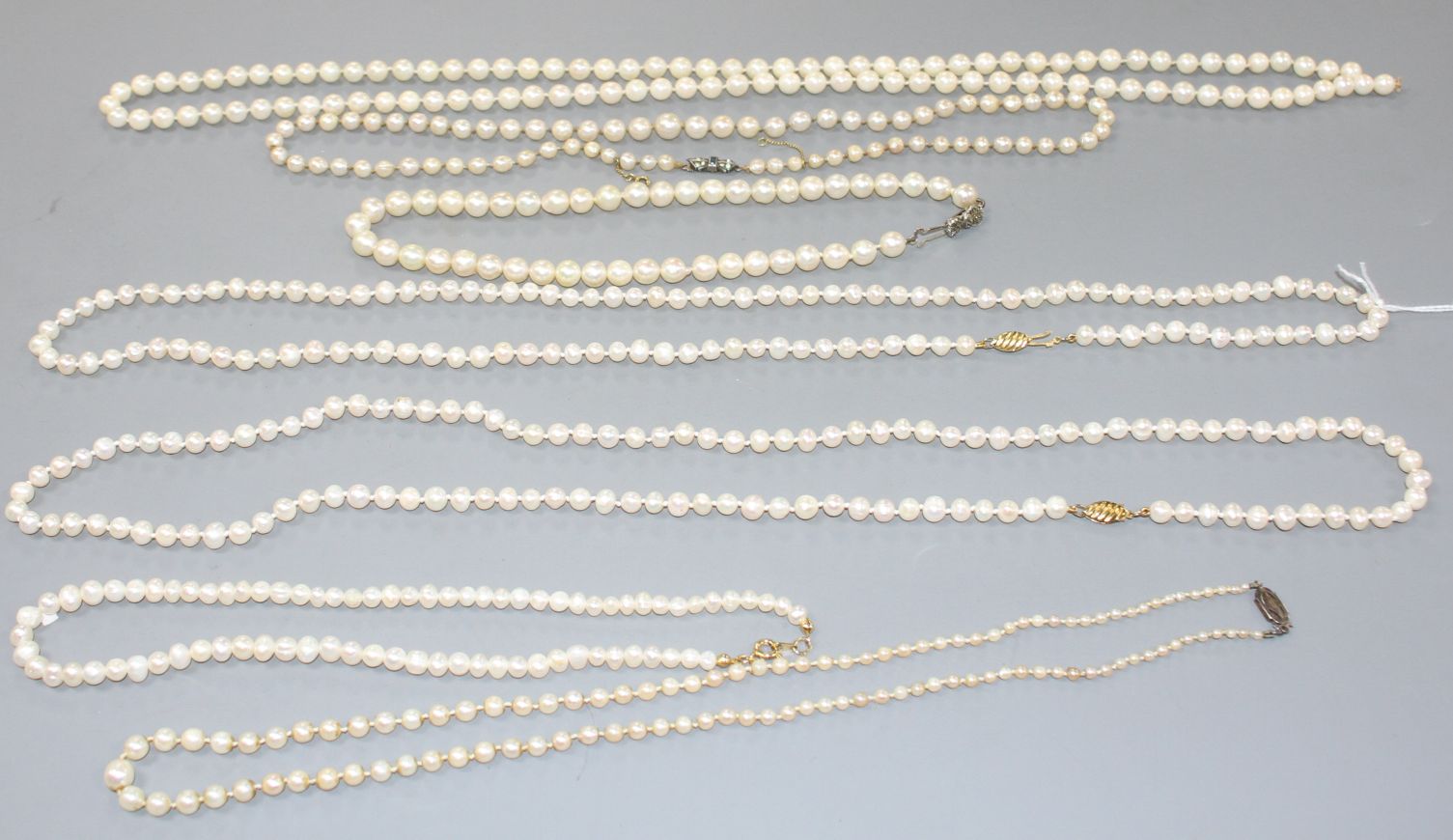 Seven assorted single strand cultured pearl necklaces, three with 925 clasps, two with 935 or 835