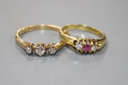 A modern 18ct gold, ruby and diamond set three stone ring and an 18ct and three stone diamond