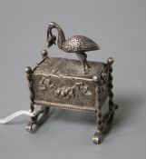 An early 20th century continental white metal novelty box and cover, modelled as a stork with baby