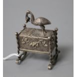 An early 20th century continental white metal novelty box and cover, modelled as a stork with baby