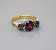 A 1930's 22ct gold, garnet and sapphire? three stone dress ring, size P/Q, gross 5 grams.