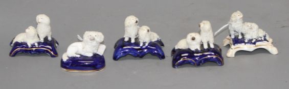 Five Staffordshire porcelain toy groups of poodles, c. 1840-50, the majority by Dudson, each on