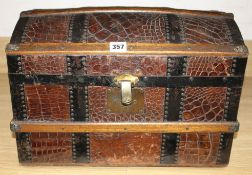 An early 20th century iron and wood bound crocodile covered miniature cabin trunk, with brass latch,