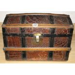 An early 20th century iron and wood bound crocodile covered miniature cabin trunk, with brass latch,