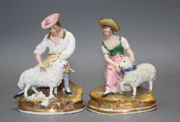 A pair of Staffordshire porcelain groups of a shepherd and shepherdess, c.1830-50, each seated,